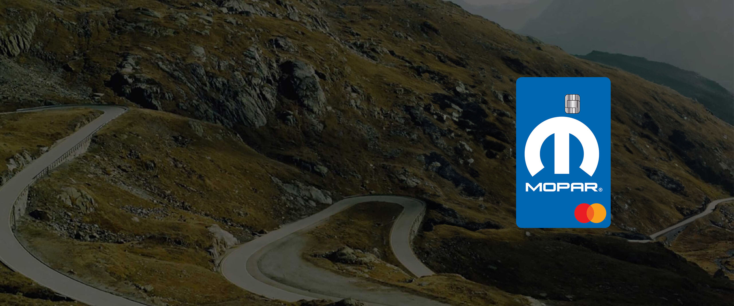 Mopar-branded Mastercard superimposed on a vista of a winding mountain road.