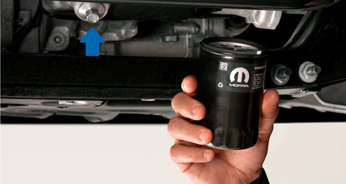 Man holding Mopar Engine Oil Filter about to install it on a Ram pickup