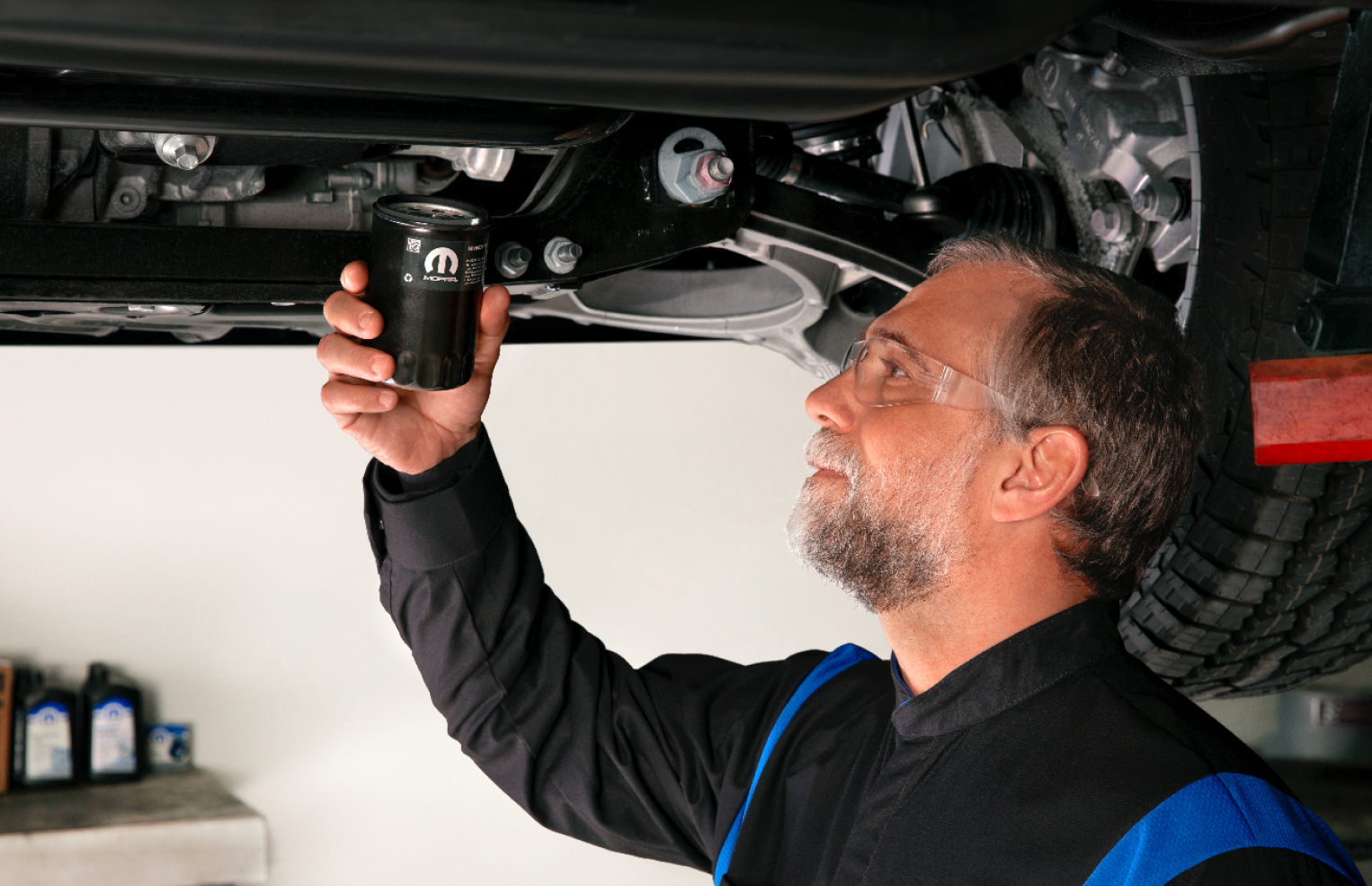 Man holding Mopar Engine Oil Filter about to install it on a Ram pickup
