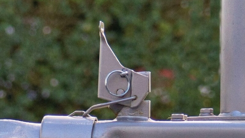 Closeup of trailer locking lever shown in the up, unlocked position