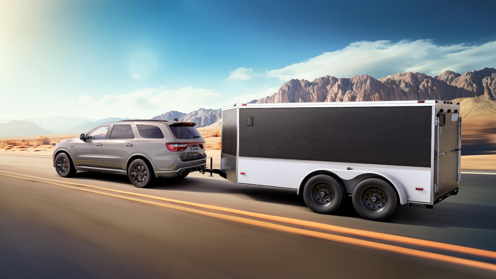 2026 Dodge Durango R/T 396 in Destroyer Gray towing cargo trailer on sunny day